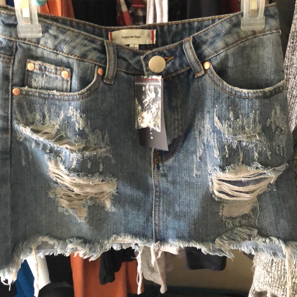 Signature Eight distressed mini jean skirt..